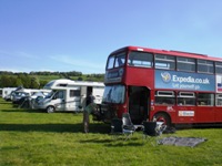 section of the site with campervan s and a Routemaster bus